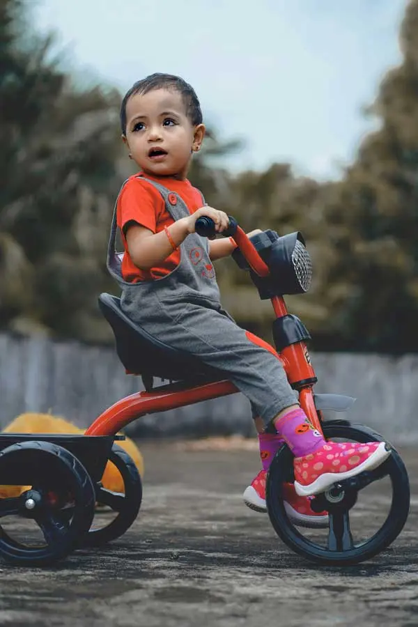 How to Teach Bike Riding - child riding a tricycle